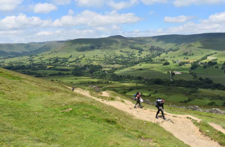pupils walking in Edale with greenery in the background